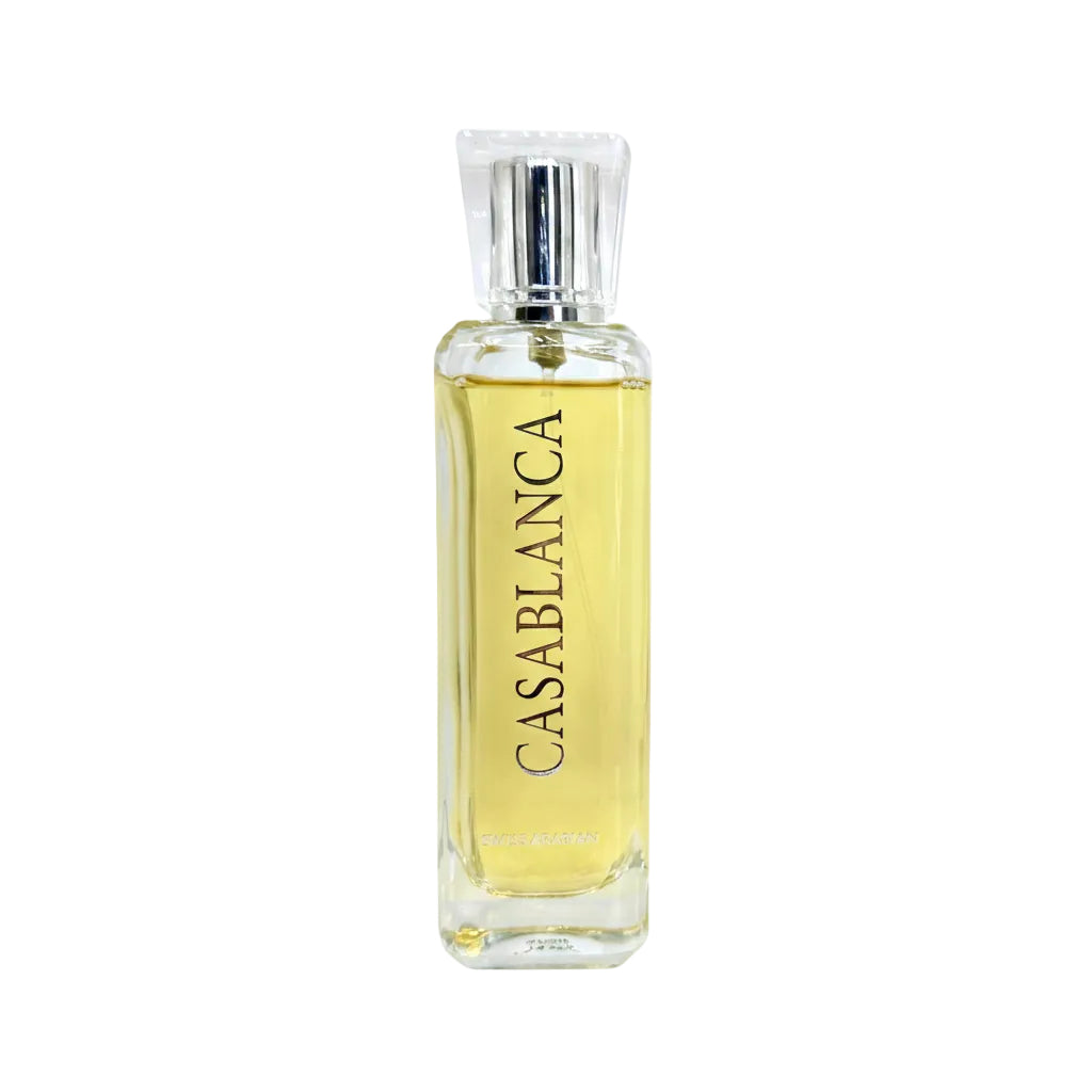 A bottle of Casablanca perfume with a silver cap and a yellow liquid, shown next to three clear sample spray vials on a white background.