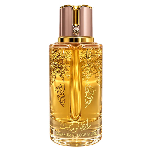 A bottle of marshmallow Musk perfume with a metallic rose gold cap and gold-toned liquid inside a clear glass bottle decorated with black floral patterns. Two small clear sample spray vials are shown next to the main bottle on a plain white background.